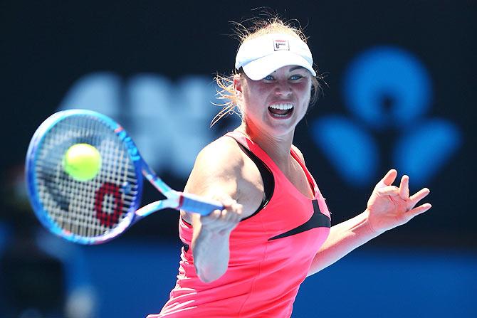 Vera Zvonareva of Russia plays a forehand against Serena Williams of the United States