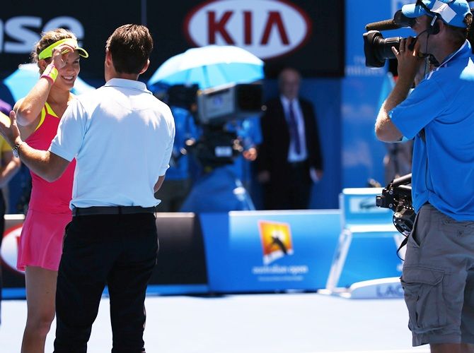Eugenie Bouchard of Canada is interviewed on the court after defeating Caroline Garcia of France