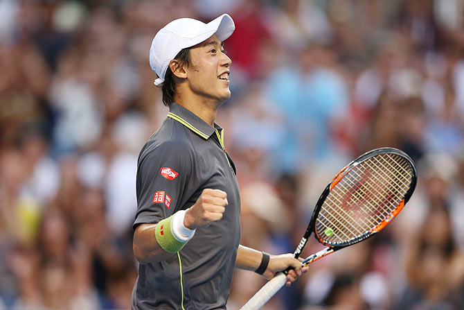Kei Nishikori of Japan celebrates winning his third round match against Steve Johnson of the United States