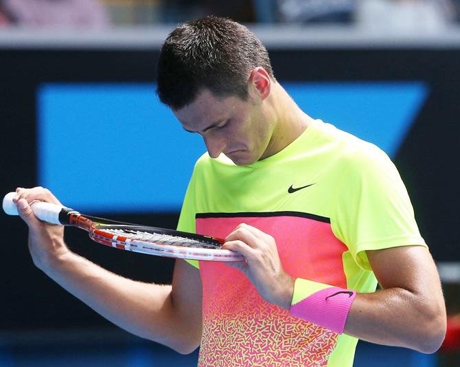 Bernard Tomic of Australia looks on