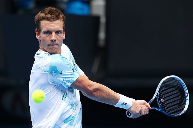 Tomas Berdych of the Czech Republic plays a backhand in his quarter-final against Rafael Nadal of Spain