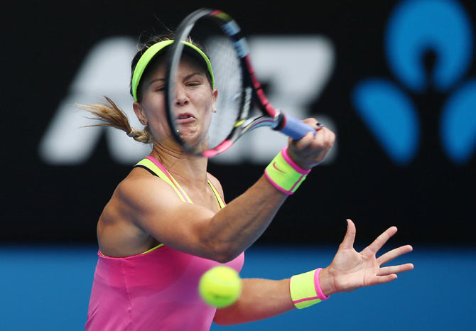 Eugenie Bouchard of Canada plays a forehand against Maria Sharapova of Russia
