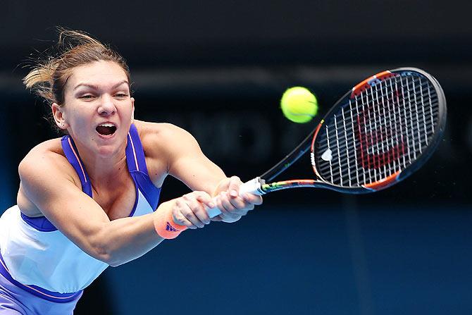 Simona Halep of Romania plays a backhand against Ekaterina Makarova of Russia 