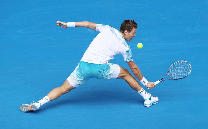 Tomas Berdych plays a backhand against Rafael Nadal