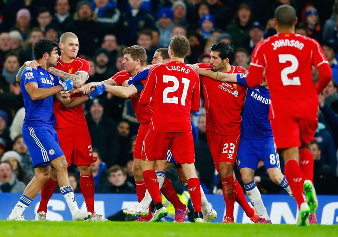 Diego Costa of Chelsea clashes with Martin Skrtel, Steven Gerrard and Emre Can of Liverpool 