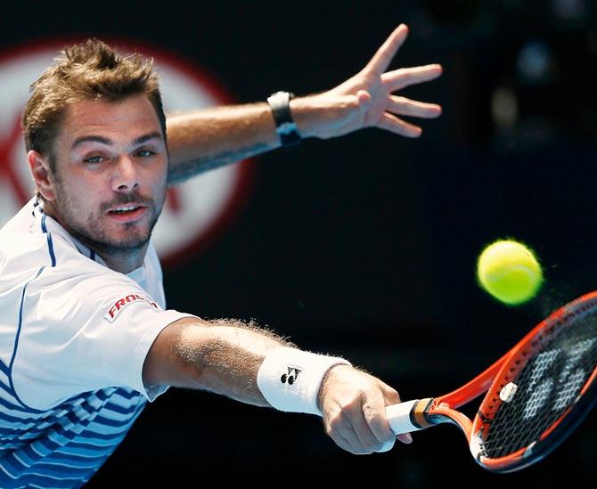 Stanislas Wawrinka of Switzerland stretches to hit a return to Kei Nishikori of Japan