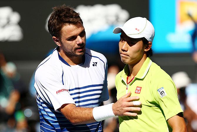 Stanislas Wawrinka of Switzerland greets Kei Nishikori of Japan at the net after winning the quarter-final of the 2015 Australian Open at Melbourne Park on Wednesday