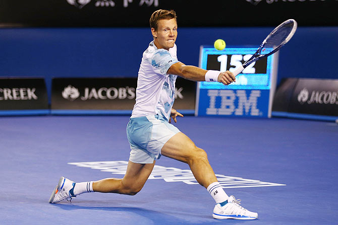 Tomas Berdych plays a backhand in his semi-final against Andy Murray