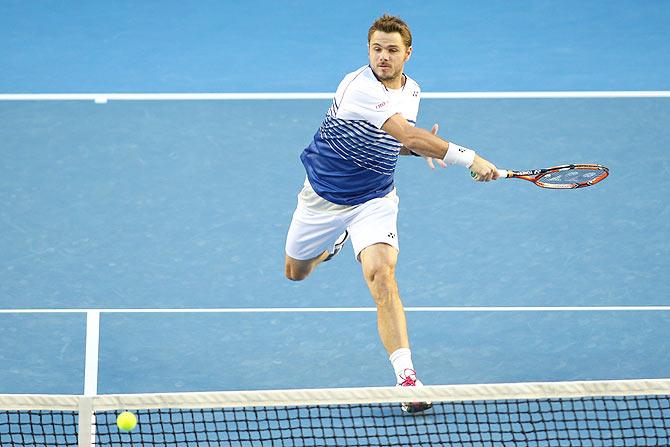 Stanislas Wawrinka of Switzerland plays a forehand in his semi-final match against Novak Djokovic of Serbi