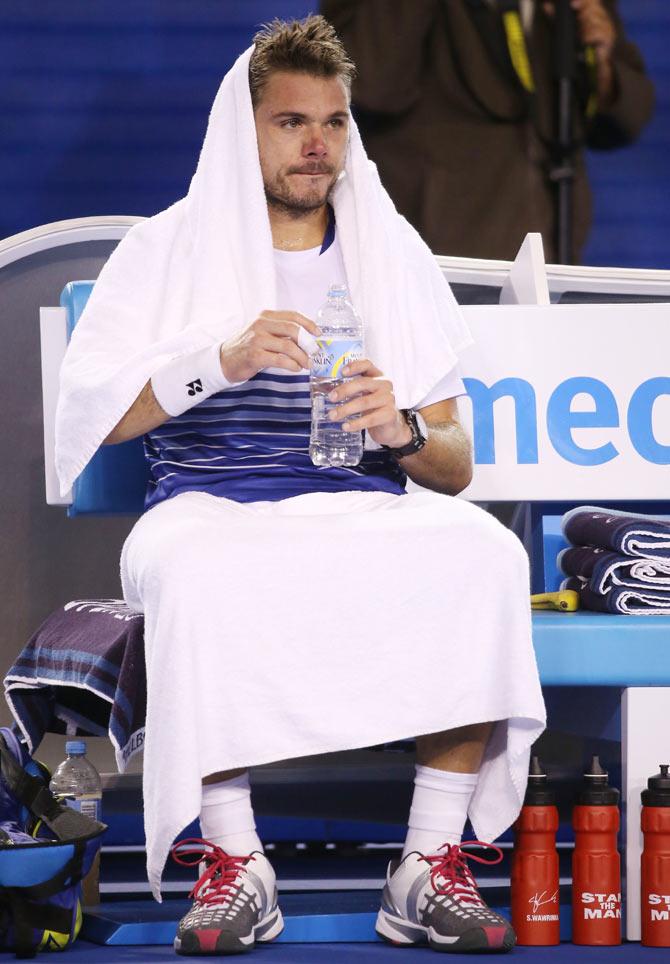 Stanislas Wawrinka of Switzerland rests during a break in his semi-final against Novak Djokovic of Serbia on Friday