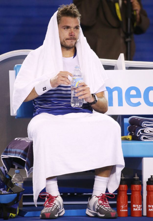 Stanislas Wawrinka of Switzerland rests during a break in his semi-final against Novak Djokovic of Serbia on Friday