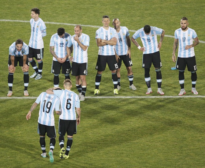 Argentina's Lucas Biglia comforts teammate Ever Banega