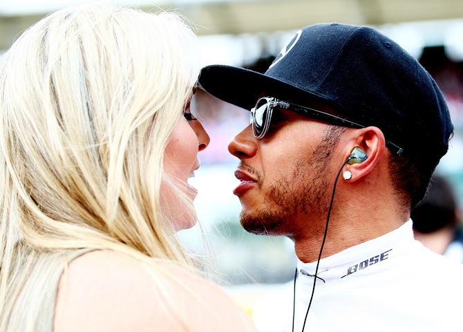 Lewis Hamilton of Great Britain and Mercedes GP speaks with Lindsey Vonn 