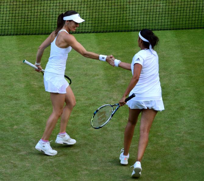 Sania Mirza (right) and Martina Hingis in action