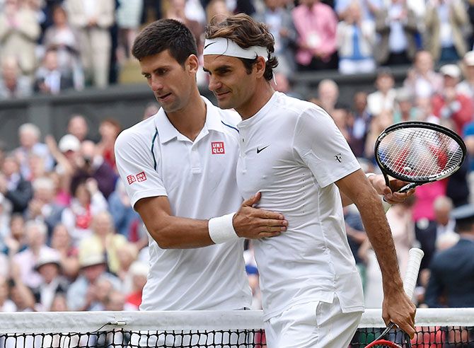 Serbia's Novak Djokovic embraces Roger Federer