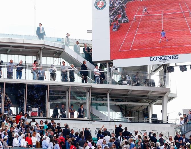 Spectators look to the corner of the court