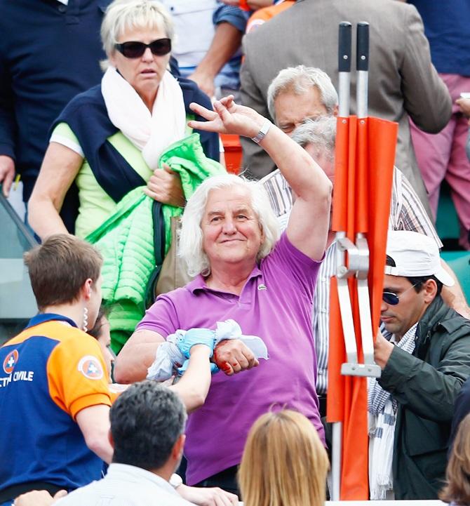 Paramedics assist spectators injured after a piece of the roof from Court Philippe   Chatrier