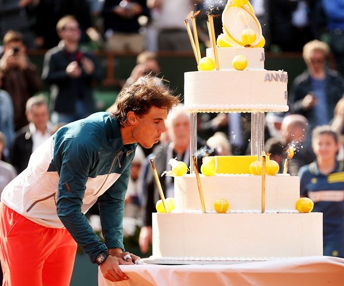 Spain's Rafael Nadal poses with a cake as he celebrates his 28th birthday