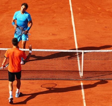 Spain's Rafael Nadal walks to the net after losing the men's quarter-final against Novak Djokovic at the 2015 French Open