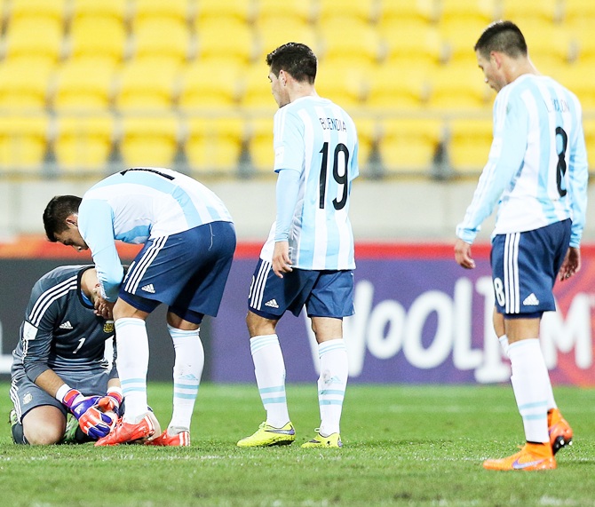 Augusto Batalla of Argentina is consoled by teammates