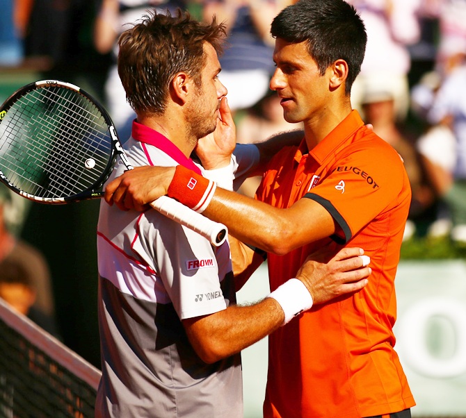 Stanislas Wawrinka of Switzerland is congratulated by Novak Djokovic