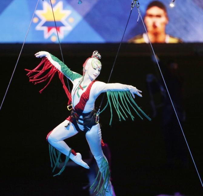 A performer dangles from a balloon