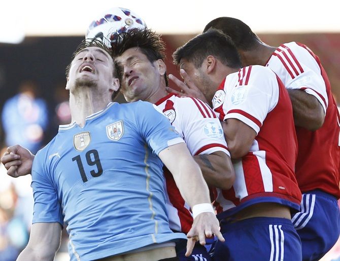 Uruguay's Sebastian Coates heads the ball