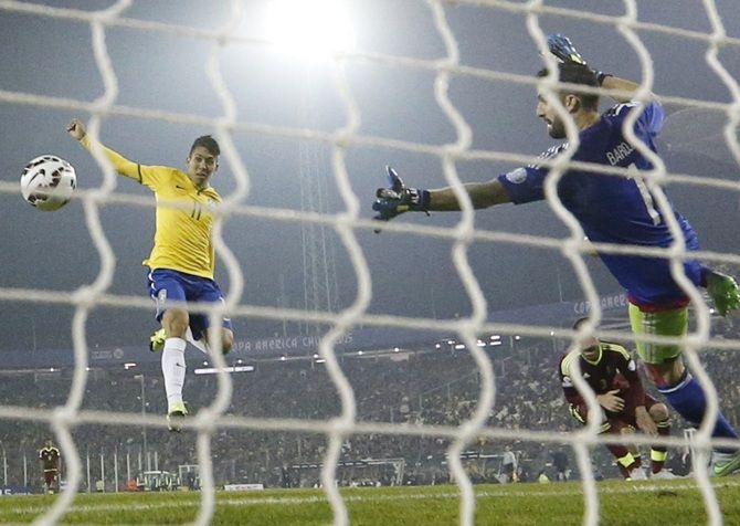 Brazil's Roberto Firmino scores past Venezuela's goalie Alain Baroja