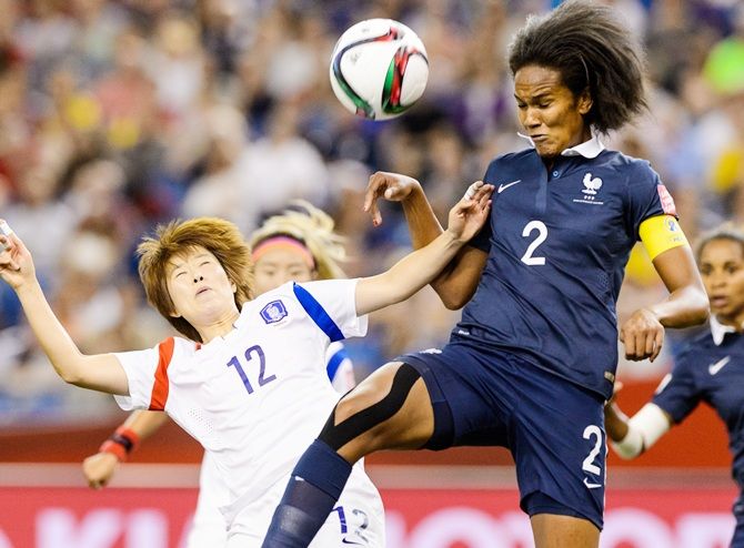  Korea's Yoo Younga and France's Wendie Renard jump for the ball