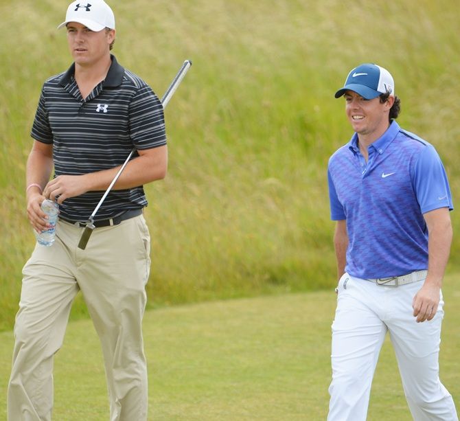 Northern Ireland's Rory McIlroy, right, and United States 's Jordan Spieth walk along the fairway
