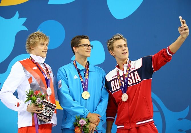 From left, silver medalist Pawel Sendyk of Poland, gold medalist Andril Khloptsov of Ukraine and bronze medalist Daniil Pakhomov of Russia pose with the medals won during the Men's 50m Butterfly final