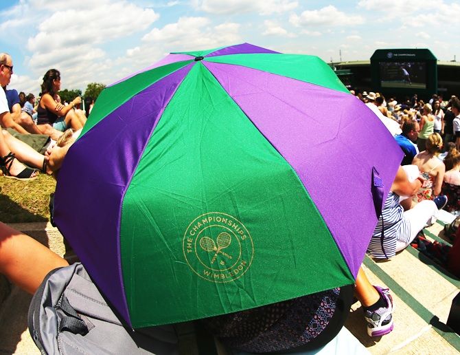 Fans sitting on Murray mound shelter from the sun