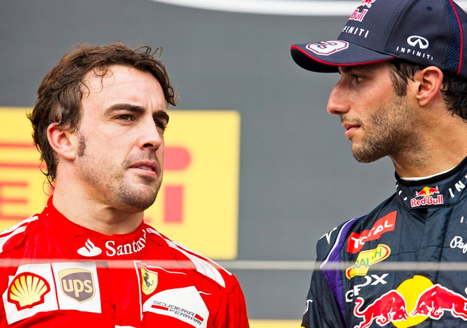 Daniel Ricciardo of Australia speaks with Fernando Alonso of Spain