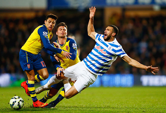 Steven Caulker of QPR is challenged by Alexis Sanchez and Olivier Giroud of Arsenal