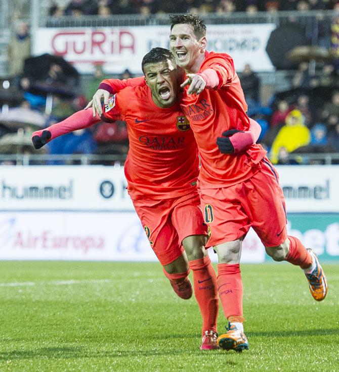 FC Barcelona's Lionel Messi celebrates with teammate Rafinha after scoring against SD Eibar during their La Liga match at Ipurua Municipal Stadium in Eibar on Saturday