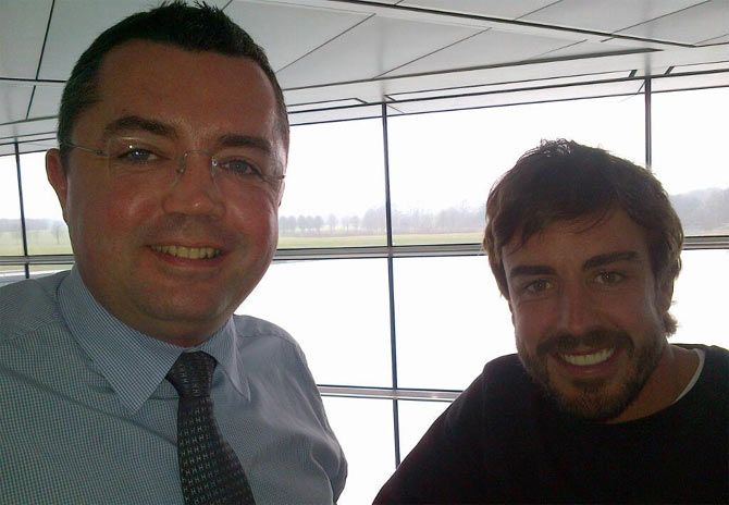 Fernando Alonso (right) with a McLaren official on Wednesday