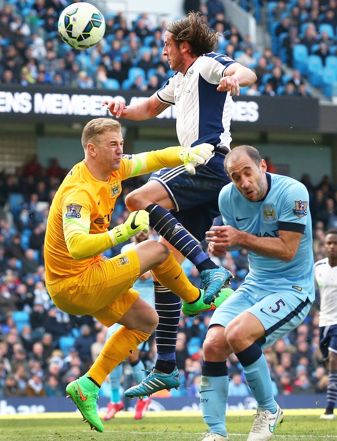 Jonas Olsson of West Brom collides with Joe Hart and Pablo Zabaleta of Manchester City