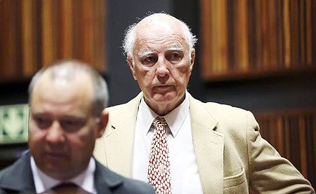 Former Grand Slam doubles champion Bob Hewitt (right) look on ahead of court proceedings at the South Gauteng High Court in Johannesburg on February 10, 2015.