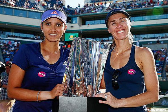 Sania Mirza of India and Martina Hingis of Switzerland with the winners trophies after defeating Ekaterina Makarova and Elena Vesnina of Russia in the doubles final