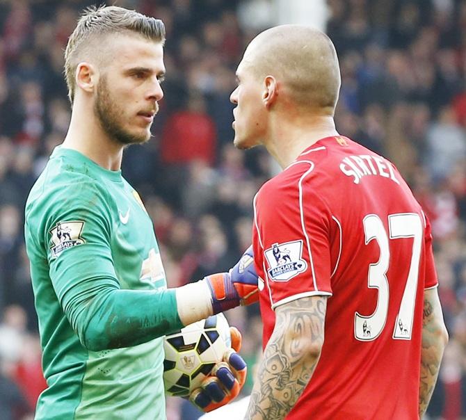 Liverpool's Martin Skrtel clashes with Manchester United's David De Gea