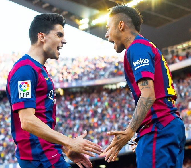 Neymar, right, of FC Barcelona celebrates with his teammate Marc Bartra