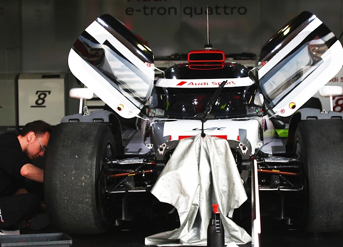 A mechanic works on the AUdi