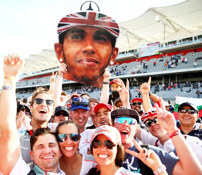 Fans of Lewis Hamilton of Great Britain and Mercedes GP celebrate his victory