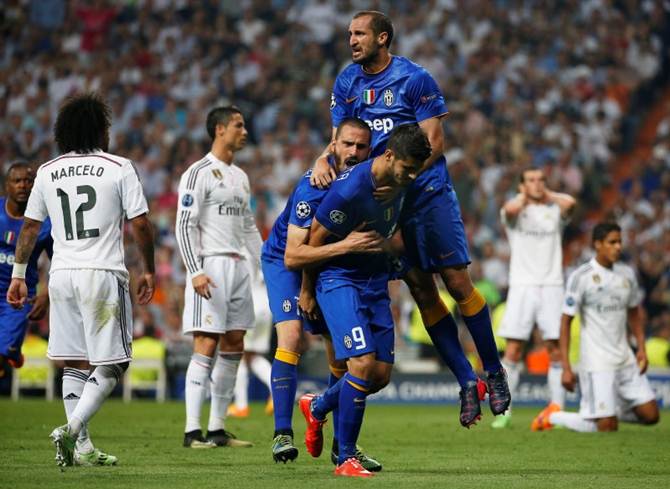 Juventus's Alvaro Morata is congratulated by teammates Leonardo Bonucci and Giorgio Chiellini after scoring 