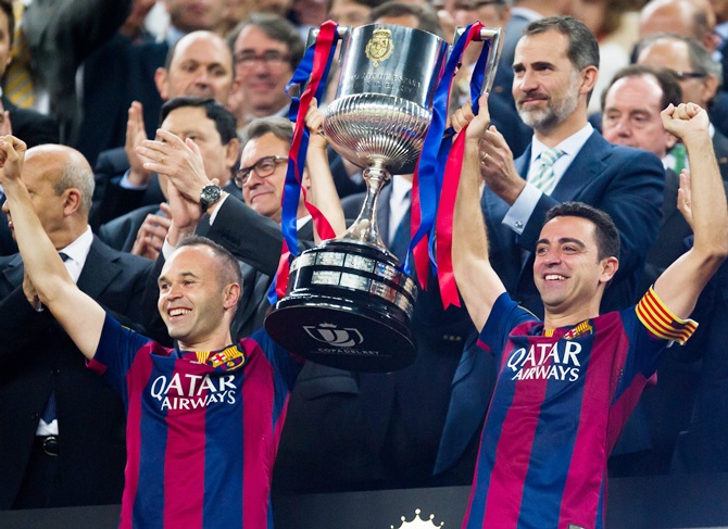 FC Barcelona's Andres Iniesta, left, and Xavi Hernandez