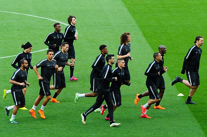 Paris Saint-Germain players warm up during a training session 