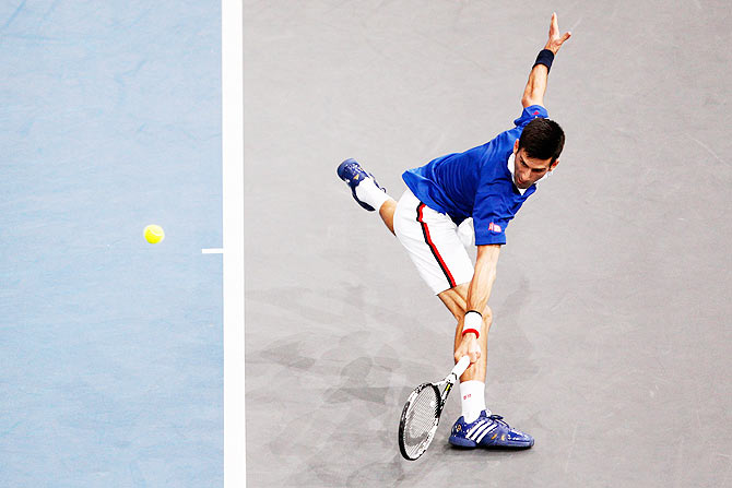 Serbia's Novak Djokovic stretches to return against France's Gilles Simon