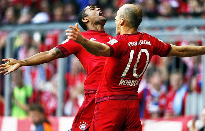 Bayern Munich's Arjen Robben (right) celebrates with Douglas Costa after scoring agains VfB Stuttgart during their Bundesliga match in Munich, on Saturday