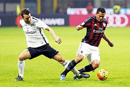 AC Milan's Carlos Bacca (right) is challenged by Atalanta's Gianpaolo Bellini during their Serie A match at the San Siro stadium in Milan on Saturday