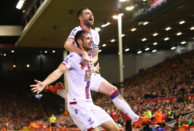Crystal Palace's Scott Dann (left) celebrates with teammate Damien Delaney after scoring his side's second goal against Liverpool during their Barclays English Premier League match at Anfield in Liverpool on Sunday